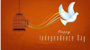 white bird is flying from cage and background is orange . happy independence day is wirtten in white colour.